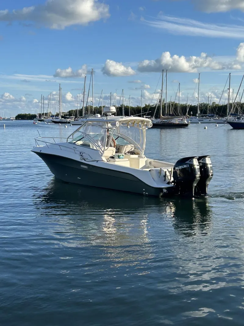 Slide: The Image of 2007 Hydra-Sports 2900 VX boat on calm water with sailboats in the background. - 5