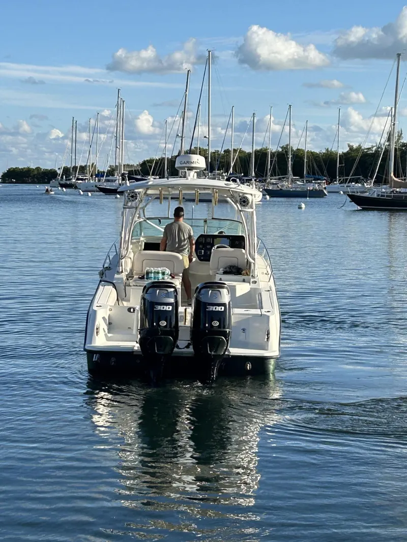 Slide: The Image of 2007 Hydra-Sports 2900 VX boat on calm water, surrounded by sailboats. - 6