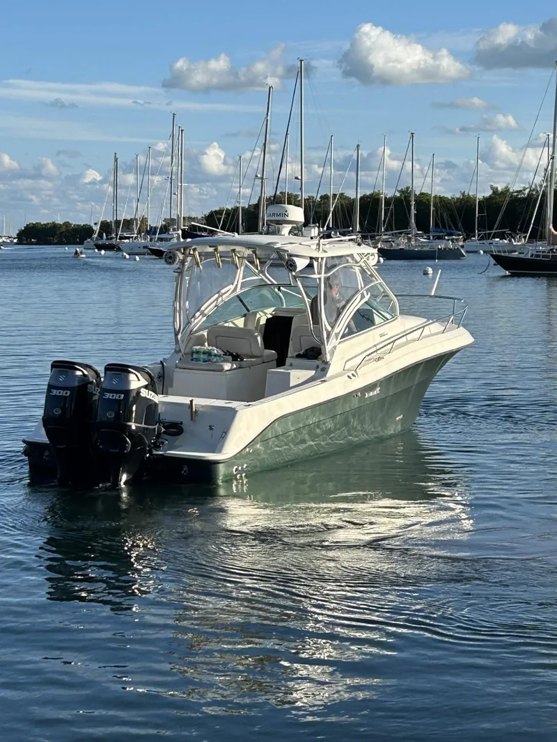 Slide: The Image of 2007 Hydra-Sports 2900 VX boat on calm water with sailboats in the background. - 7