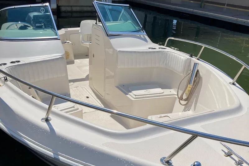 Slide: The Image of 2007 Cobia 215 Dual Console boat with spacious seating, docked in a marina. - 3
