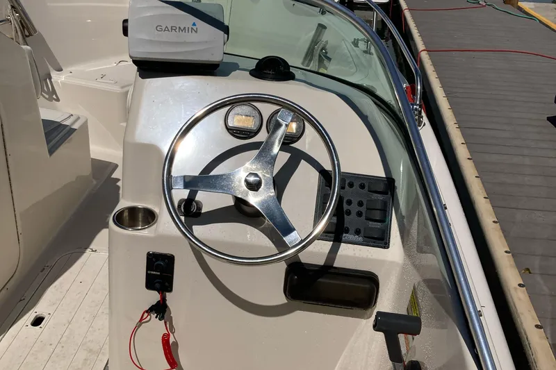 Slide: The Image of Steering console of a 2007 Cobia 215 Dual Console boat with Garmin navigation. - 6