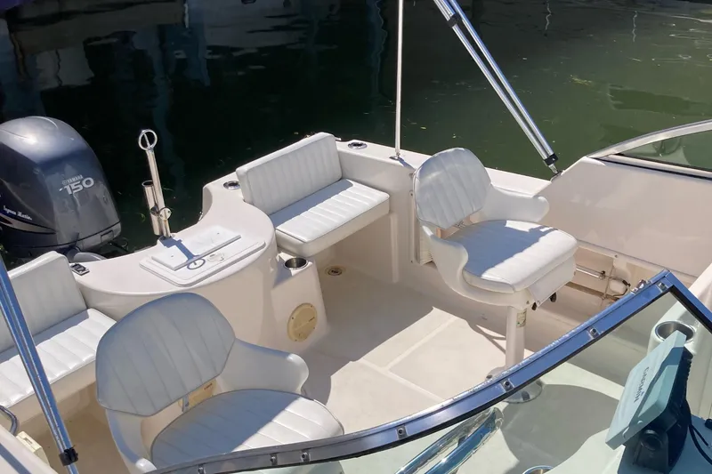 Slide: The Image of 2007 Cobia 215 Dual Console boat interior with seating and Yamaha 150 outboard motor. - 8