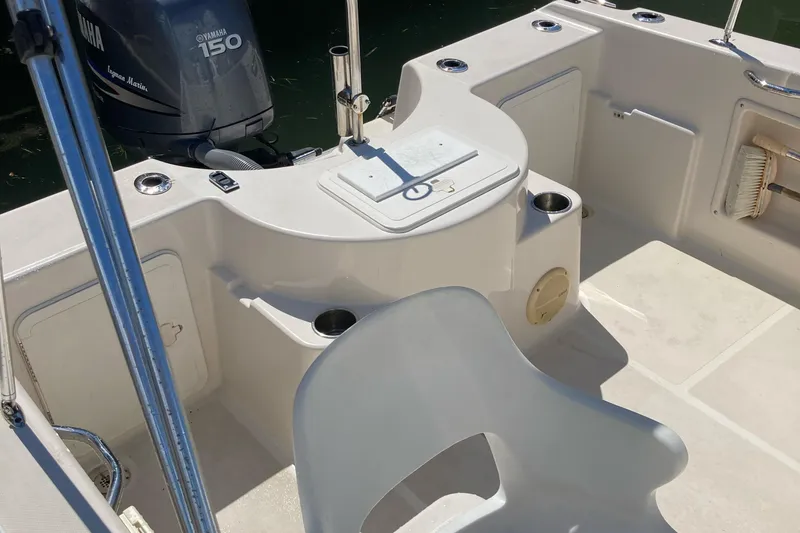 Slide: The Image of 2007 Cobia 215 Dual Console boat interior with Yamaha 150 engine. - 9