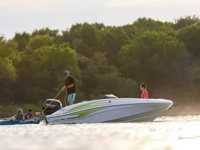 Slide: The Image of 2024 Tahoe T16 boat on water with people enjoying outdoor activities. - 1