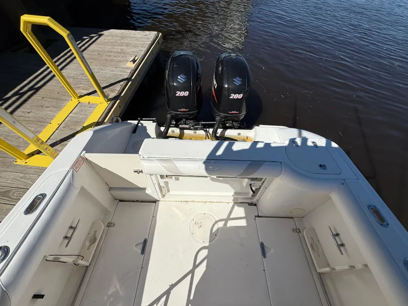 Slide: The Image of 2003 Boston Whaler 240 Outrage boat with twin 200 horsepower engines at dock. - 12