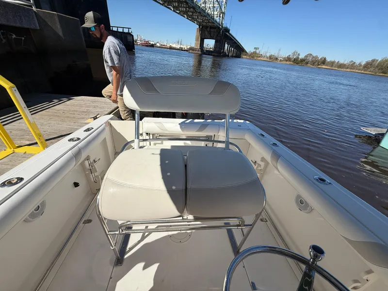Slide: The Image of 2003 Boston Whaler 240 Outrage boat interior near dock and bridge. - 13