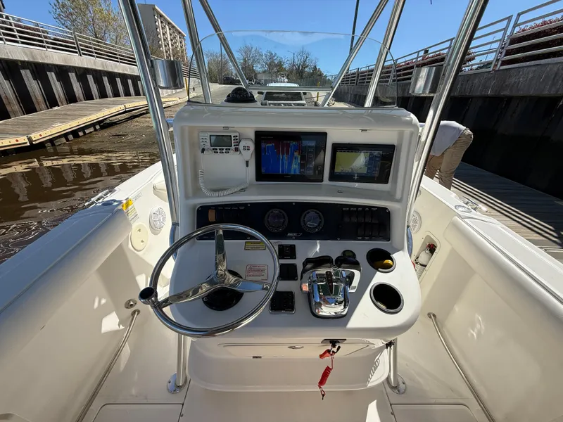 Slide: The Image of 2003 Boston Whaler 240 Outrage boat console with steering wheel and navigation screens. - 14