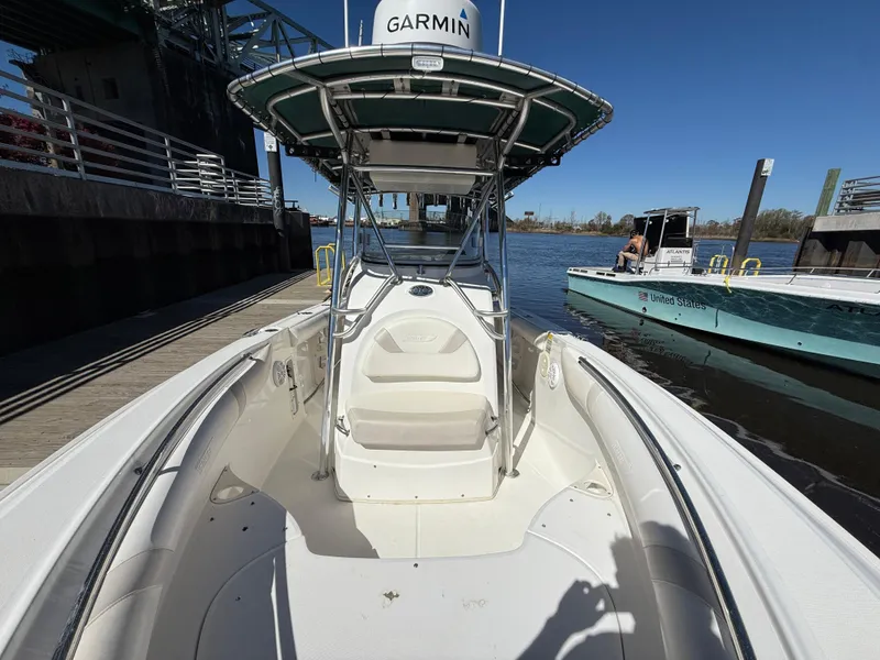 Slide: The Image of 2003 Boston Whaler 240 Outrage boat docked, featuring Garmin equipment and spacious seating. - 21