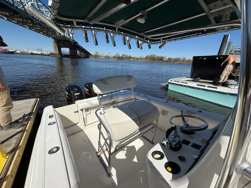 Slide: The Image of 2003 Boston Whaler 240 Outrage boat docked near a bridge on a sunny day. - 22