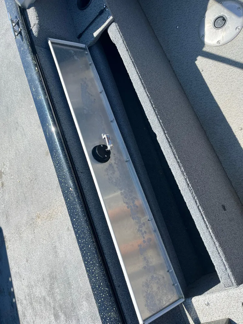 Slide: The Image of 2018 Tracker PRO GUIDE V165 WT boat storage compartment, open and empty. - 11