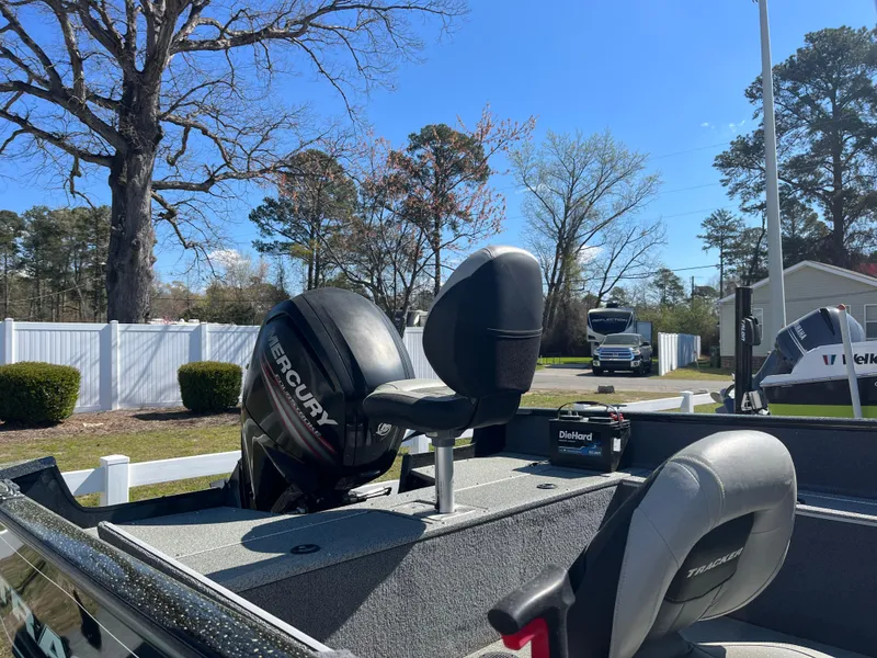 Slide: The Image of 2018 Tracker PRO GUIDE V165 WT boat with Mercury engine in a residential area. - 4
