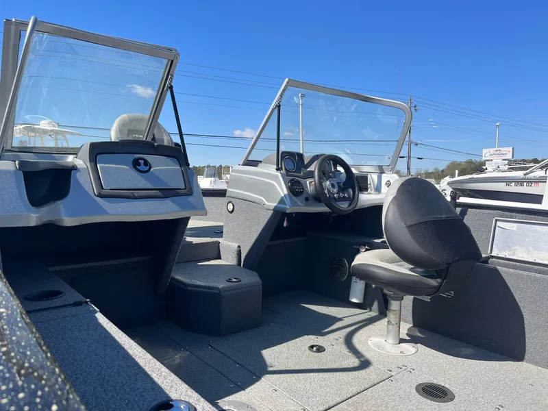Slide: The Image of 2018 Tracker PRO GUIDE V165 WT boat interior with steering wheel and seating. - 6
