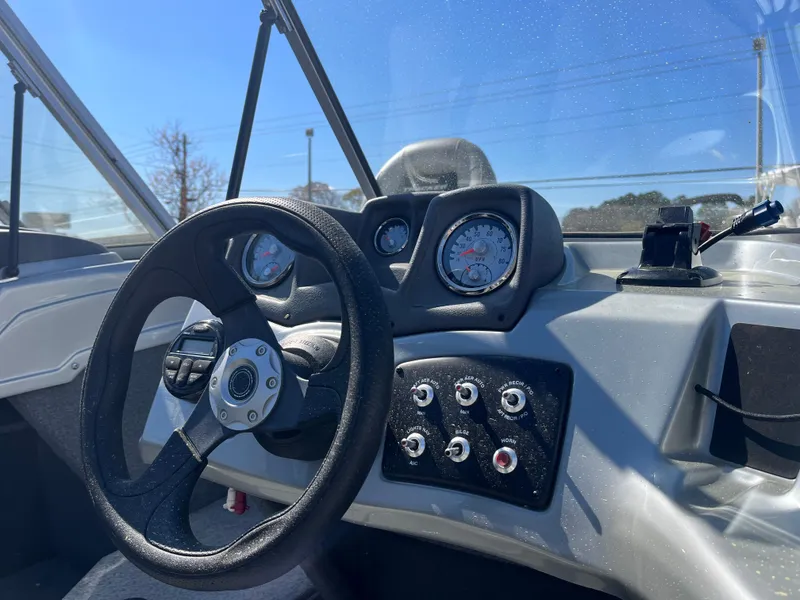 Slide: The Image of 2018 Tracker PRO GUIDE V165 WT boat dashboard with steering wheel and control panel. - 9