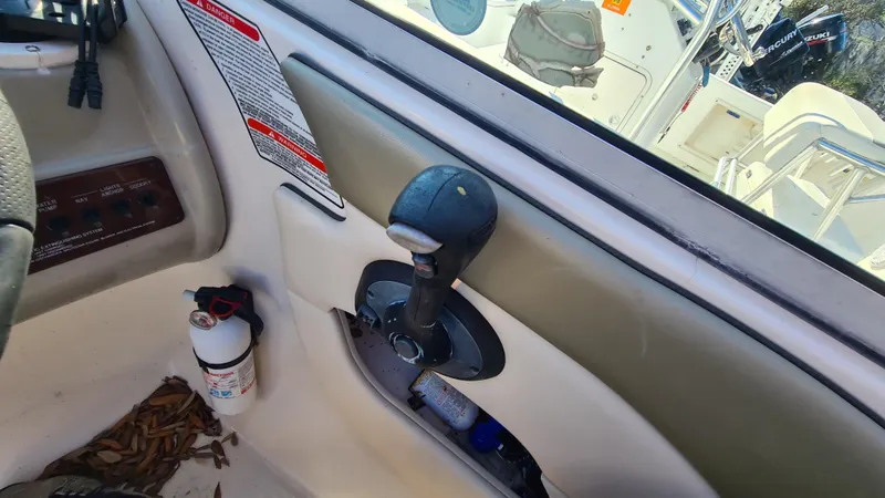 Slide: The Image of 2005 Sea Ray 200 Sundeck boat throttle control and cockpit interior. - 11