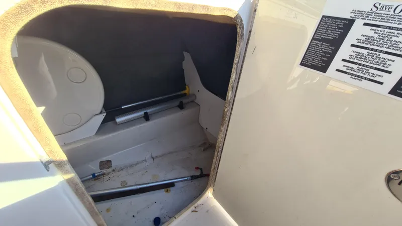 Slide: The Image of 2005 Sea Ray 200 Sundeck storage compartment with open hatch and visible interior details. - 13