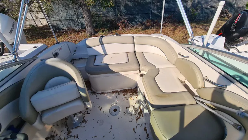 Slide: The Image of 2005 Sea Ray 200 Sundeck interior with beige seating and outdoor setting. - 16