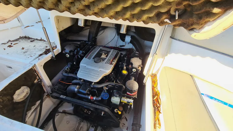 Slide: The Image of Engine compartment of a 2005 Sea Ray 200 Sundeck boat, showcasing the motor and interior details. - 22