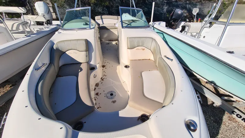 Slide: The Image of 2005 Sea Ray 200 Sundeck boat interior with spacious seating and dual consoles. - 5
