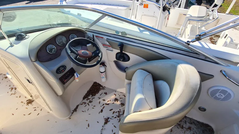 Slide: The Image of 2005 Sea Ray 200 Sundeck boat interior with steering wheel and seating area. - 6
