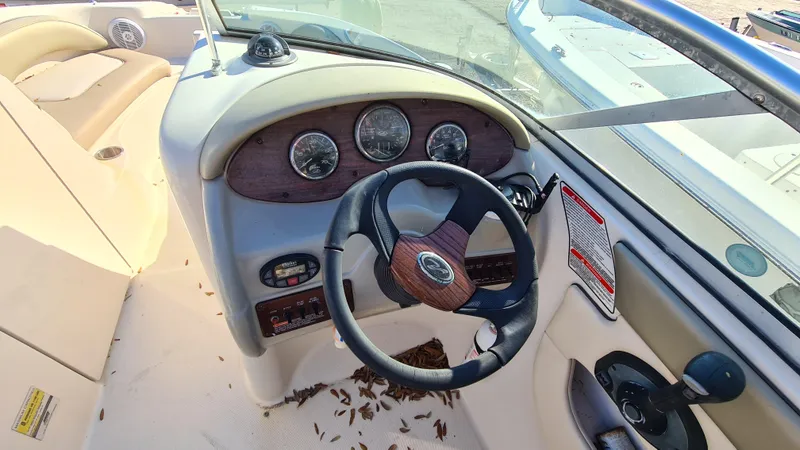 Slide: The Image of 2005 Sea Ray 200 Sundeck boat dashboard with steering wheel and gauges. - 7