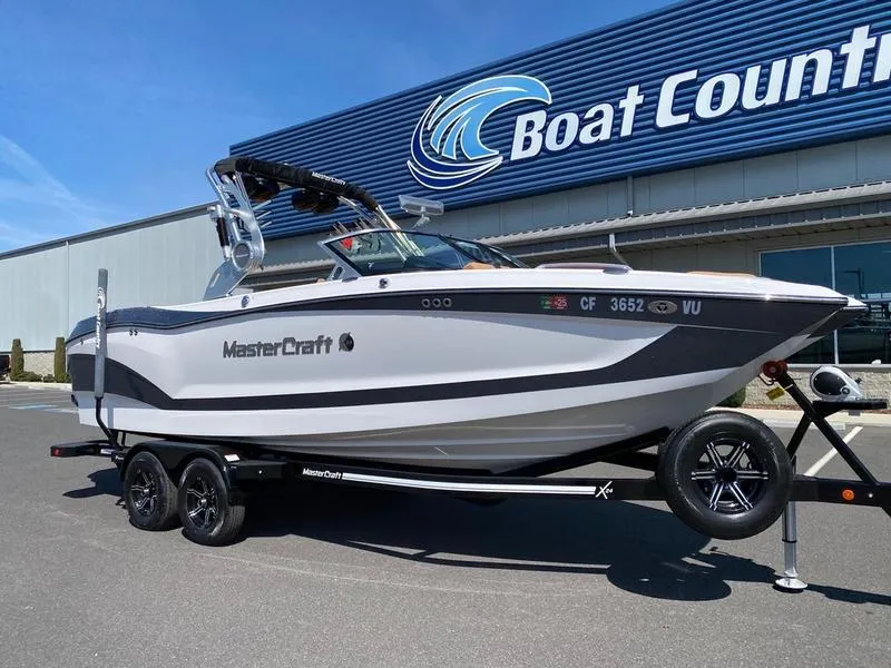 Slide: The Image of 2021 MasterCraft X24 boat on trailer at Boat Country dealership. - 1
