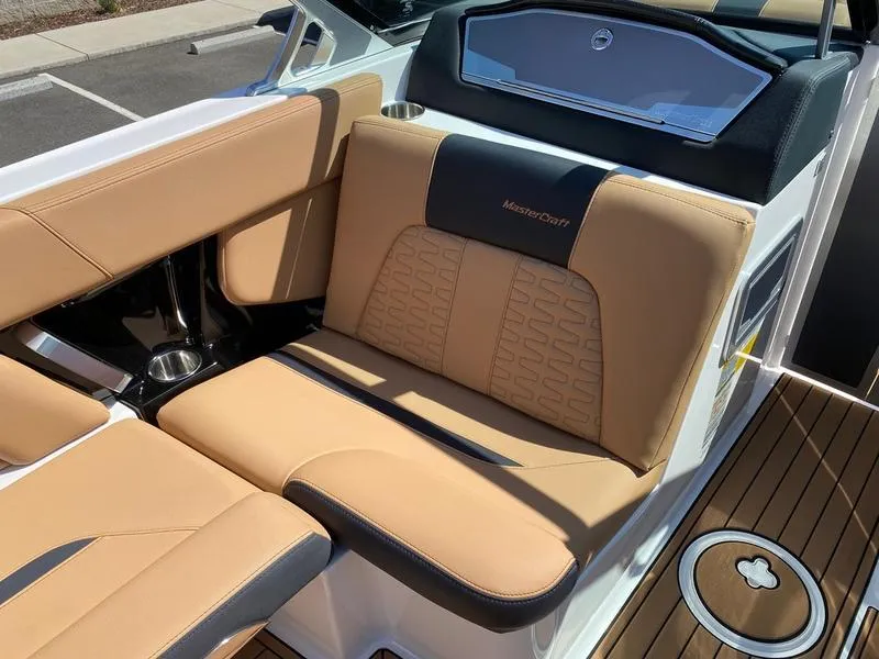 Slide: The Image of 2021 MasterCraft X24 boat interior with tan leather seating and sleek design. - 11