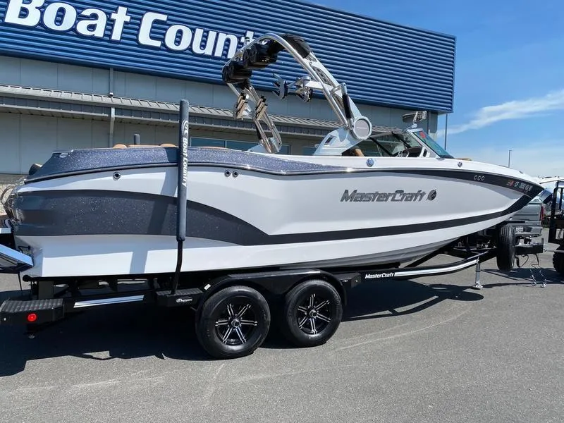 Slide: The Image of 2021 MasterCraft X24 boat on trailer at dealership, side view. - 2
