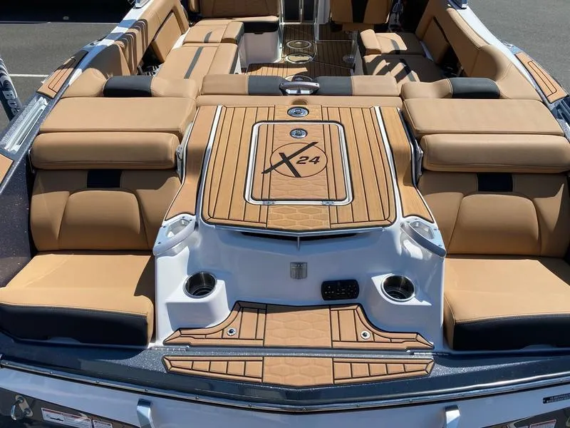 Slide: The Image of 2021 MasterCraft X24 boat interior with tan upholstery and sleek design. - 4
