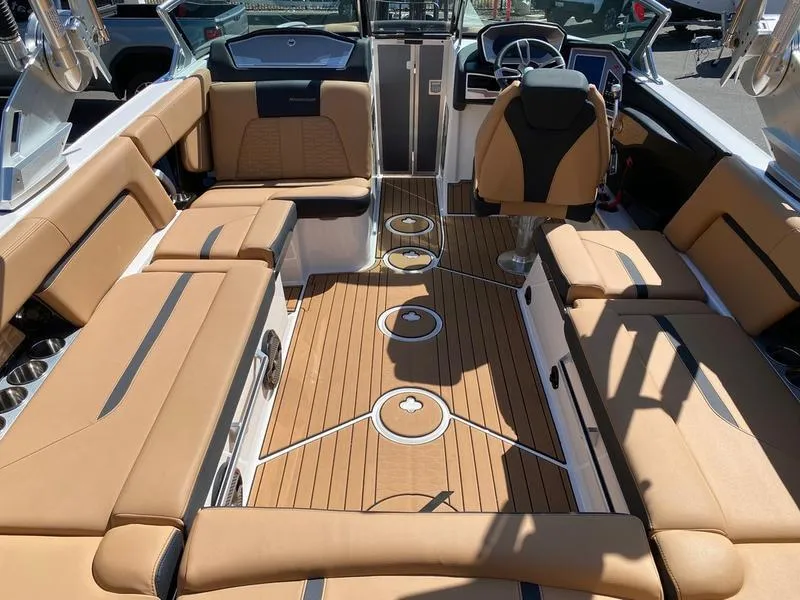 Slide: The Image of 2021 MasterCraft X24 boat interior with tan seating and sleek design. - 6