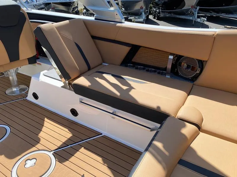 Slide: The Image of 2021 MasterCraft X24 boat interior with tan seating and teak flooring. - 7