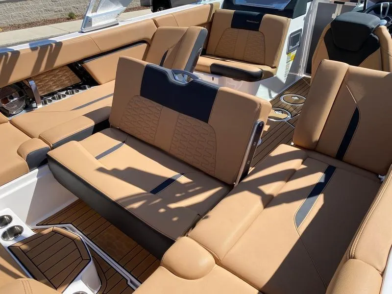Slide: The Image of 2021 MasterCraft X24 boat interior with tan leather seating and modern design. - 9