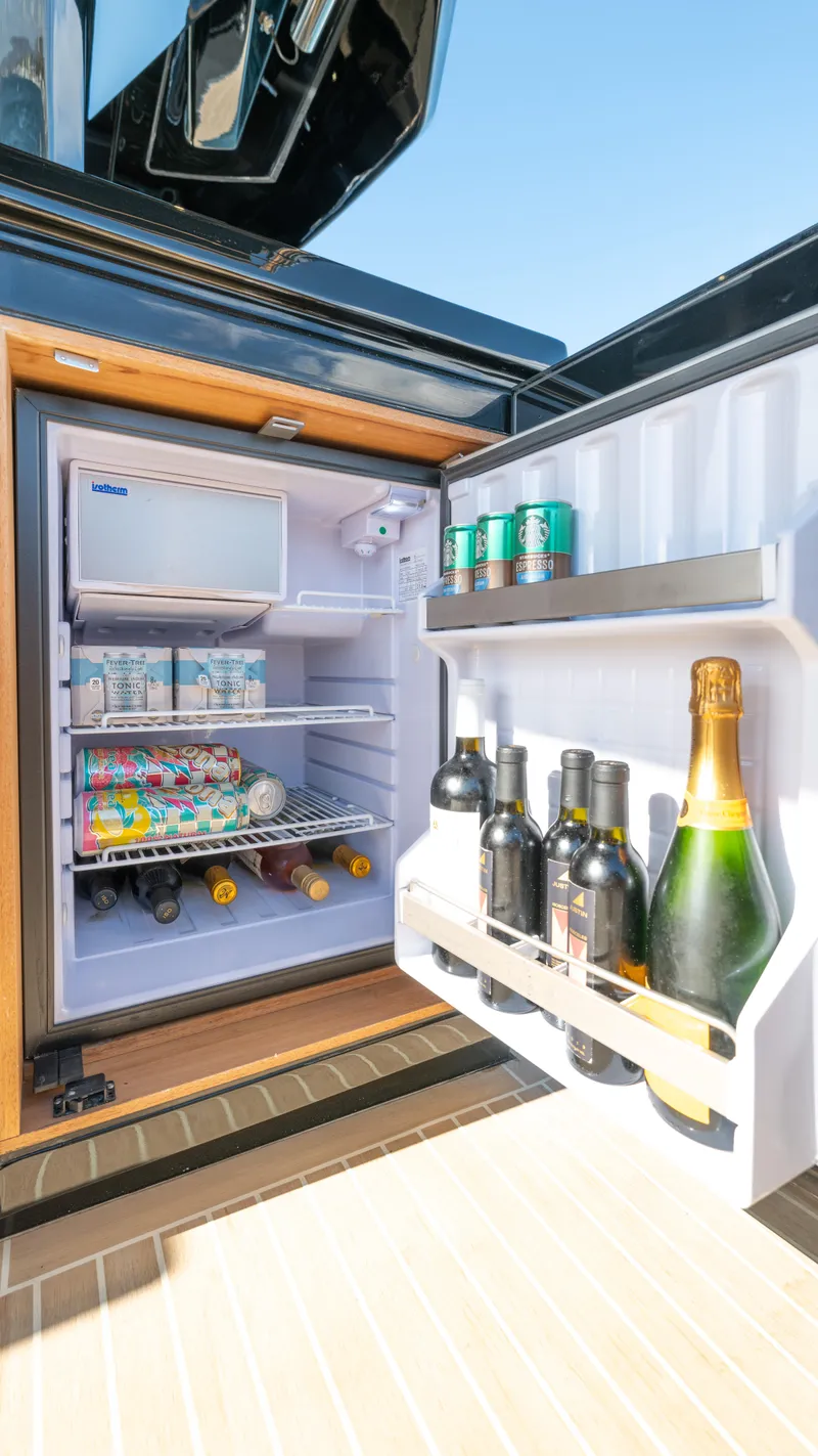 Slide: The Image of Open fridge on 2022 Pardo Yachts 50, stocked with drinks and snacks. - 34