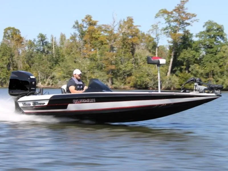 Slide: The Image of 2018 Blazer 595 Pro Elite boat speeding on a lake with trees in the background. - 1