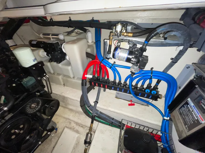 Slide: The Image of Engine compartment of a 2005 Sea Ray 300 Sundancer with visible wiring and components. - 10