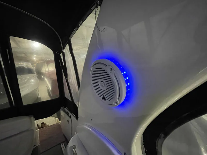 Slide: The Image of 2005 Sea Ray 300 Sundancer interior with illuminated speaker and seating area. - 14