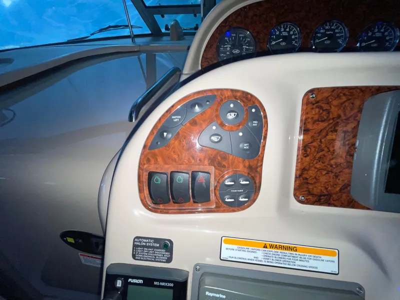 Slide: The Image of Control panel of a 2005 Sea Ray 300 Sundancer boat with wood finish and gauges. - 17