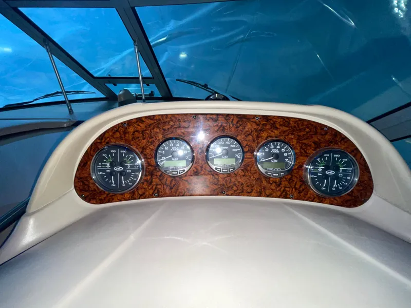 Slide: The Image of Dashboard of 2005 Sea Ray 300 Sundancer boat with gauges and wood paneling. - 20