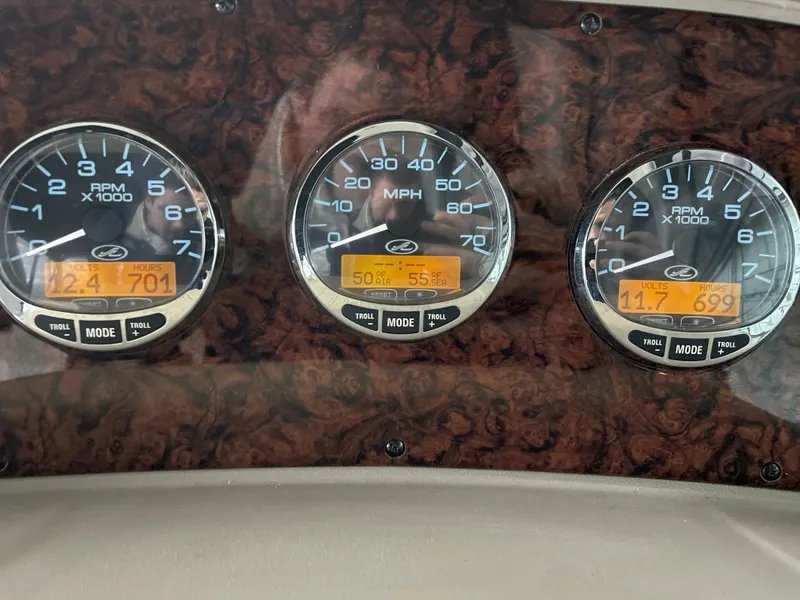 Slide: The Image of Dashboard gauges of a 2005 Sea Ray 300 Sundancer boat. - 21
