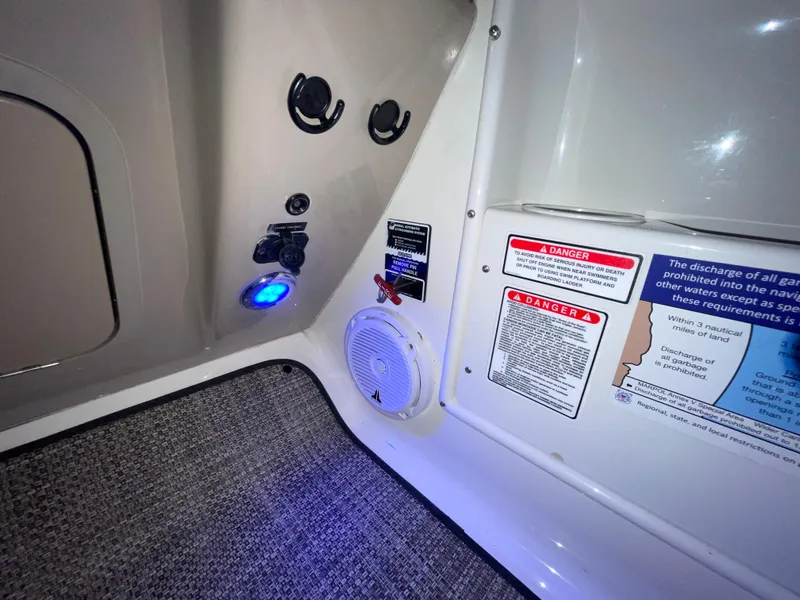 Slide: The Image of 2005 Sea Ray 300 Sundancer interior with control panel, speaker, and safety warnings. - 22