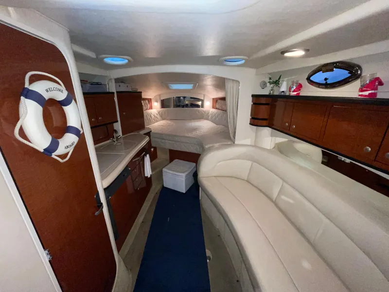 Slide: The Image of Interior of 2005 Sea Ray 300 Sundancer boat with cozy seating and sleeping area. - 25