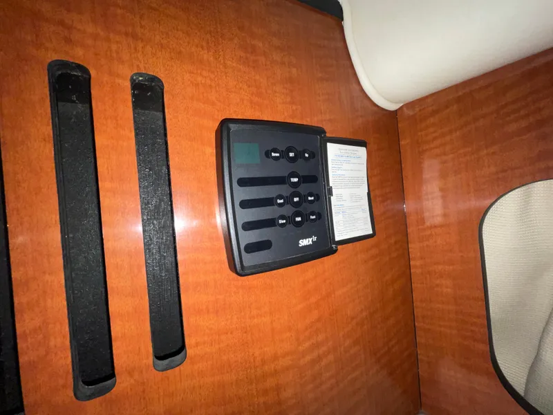 Slide: The Image of Control panel on 2005 Sea Ray 300 Sundancer boat interior with wood finish. - 31