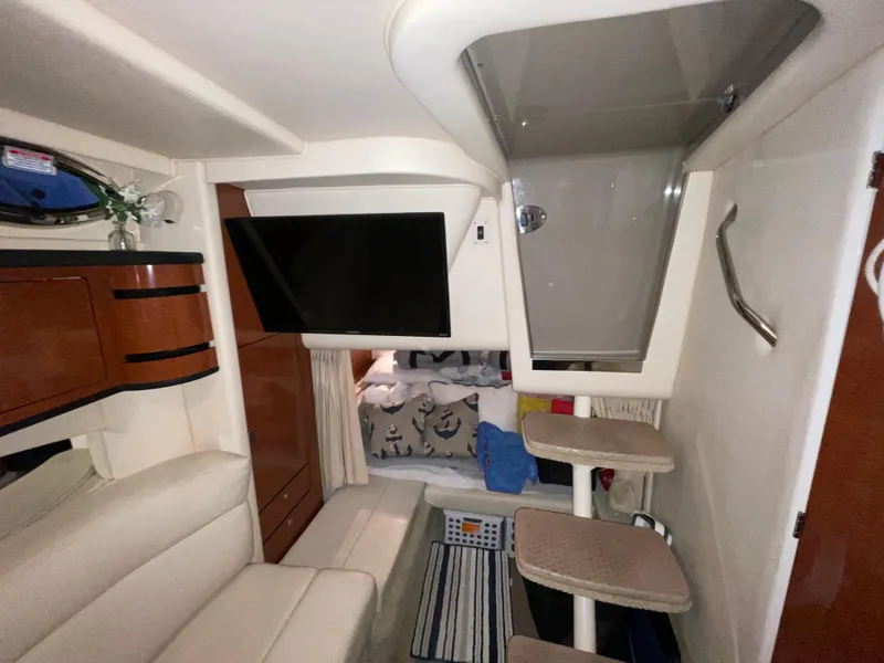Slide: The Image of Interior of 2005 Sea Ray 300 Sundancer with seating, TV, and steps to cabin. - 32