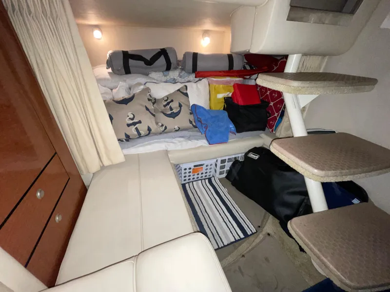 Slide: The Image of Interior cabin of 2005 Sea Ray 300 Sundancer with bedding and storage. - 33