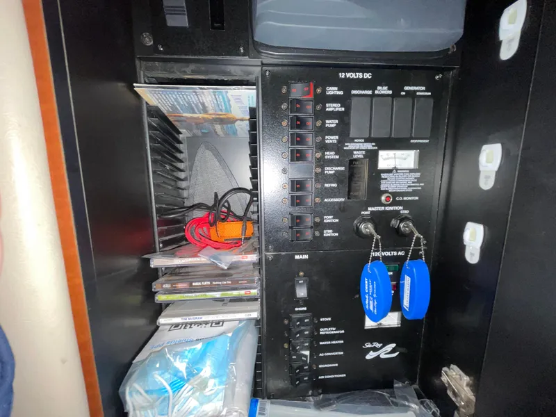 Slide: The Image of Electrical panel of a 2005 Sea Ray 300 Sundancer boat with organized wiring and accessories. - 35