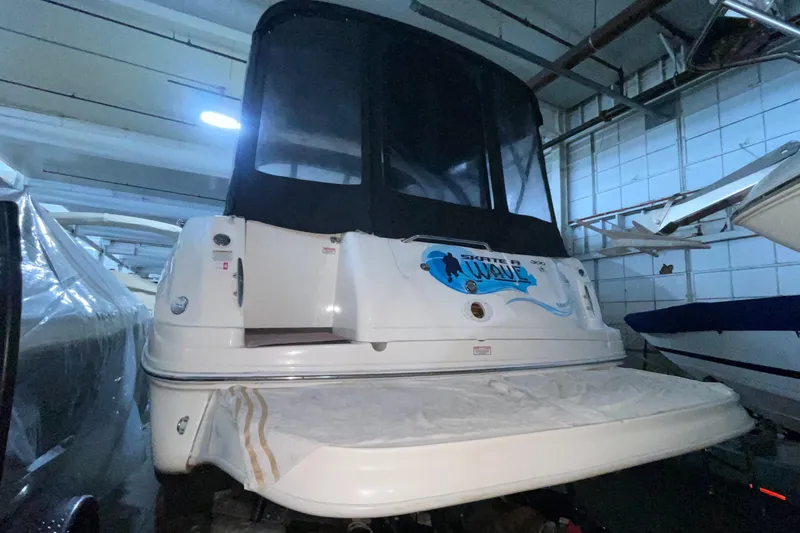 Slide: The Image of 2005 Sea Ray 300 Sundancer boat in indoor storage, rear view. - 4