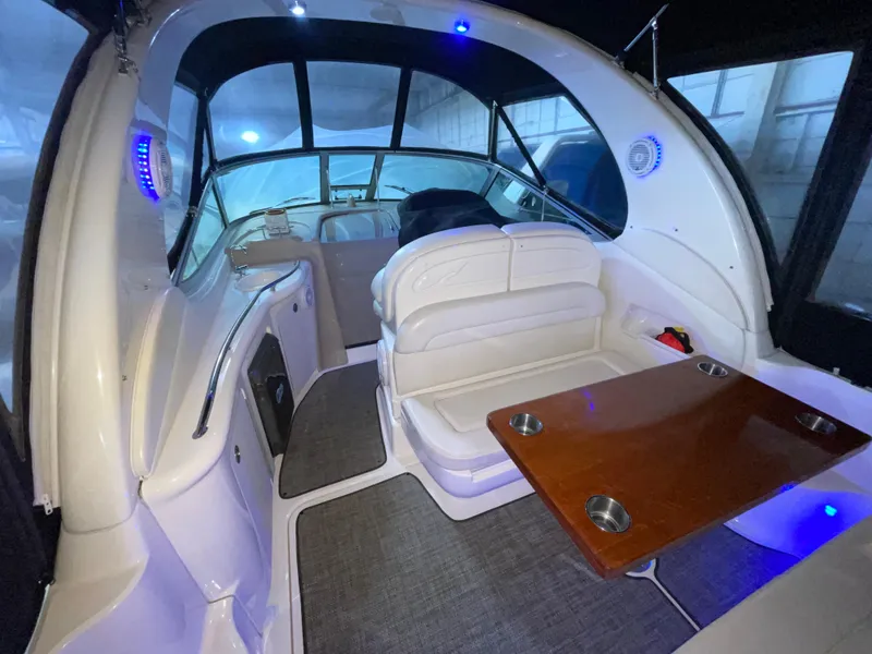 Slide: The Image of 2005 Sea Ray 300 Sundancer interior with seating and table, featuring modern design and lighting. - 5