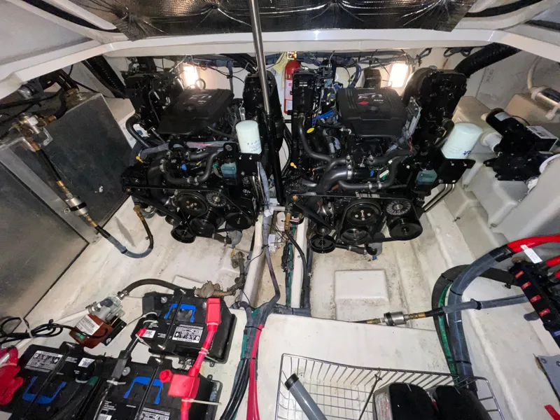Slide: The Image of Engine room of a 2005 Sea Ray 300 Sundancer with dual engines and battery setup. - 9