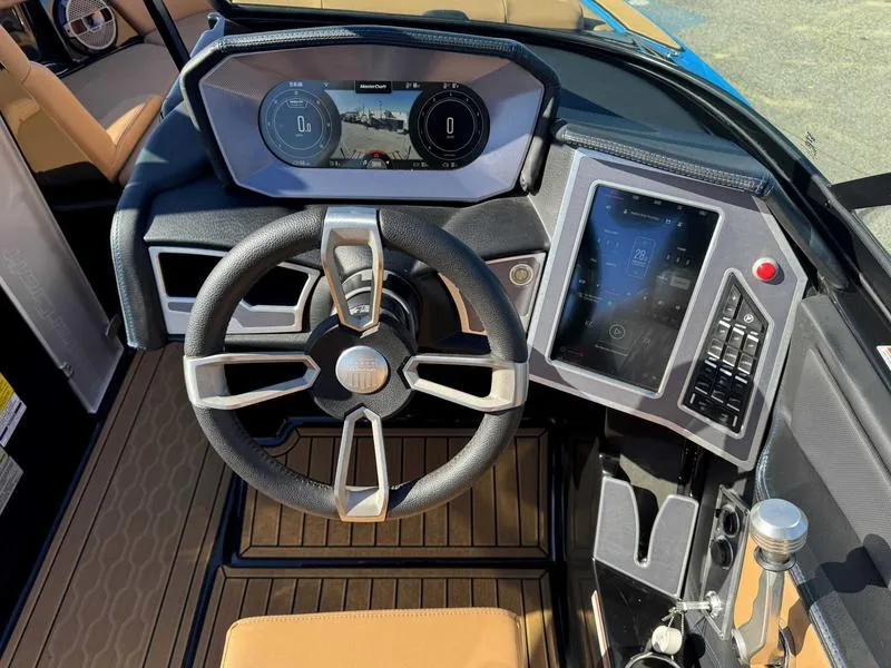Slide: The Image of 2022 MasterCraft XT23 boat dashboard with modern steering and digital displays. - 12