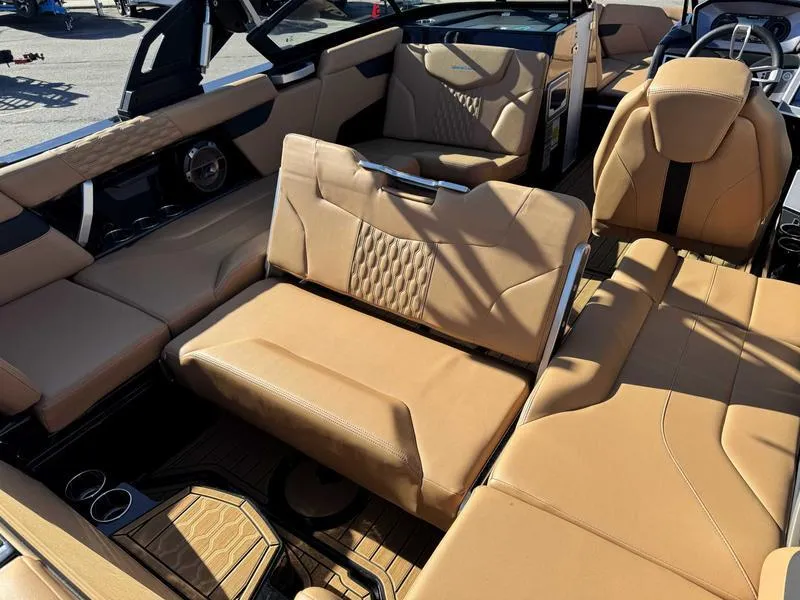 Slide: The Image of 2022 MasterCraft XT23 boat interior with luxurious tan seating and modern design. - 16
