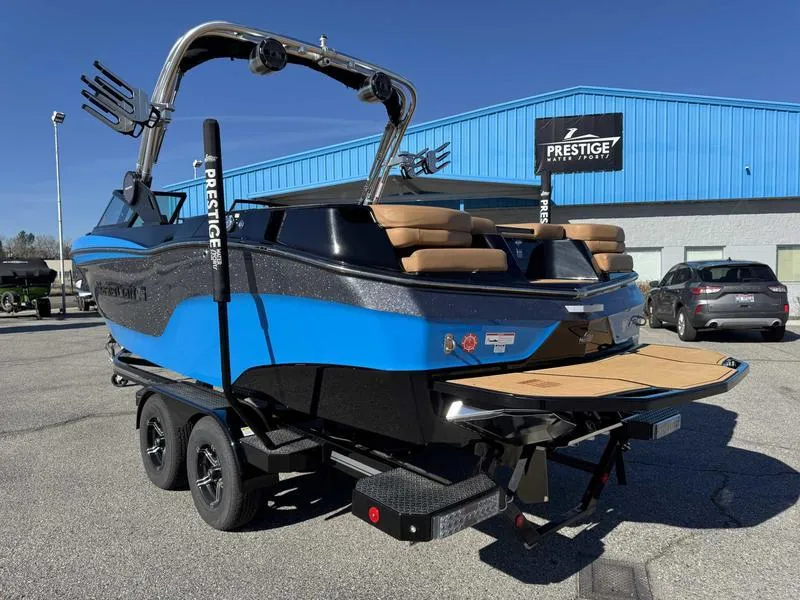 Slide: The Image of 2022 MasterCraft XT23 boat in blue and black on a trailer outside a dealership. - 6